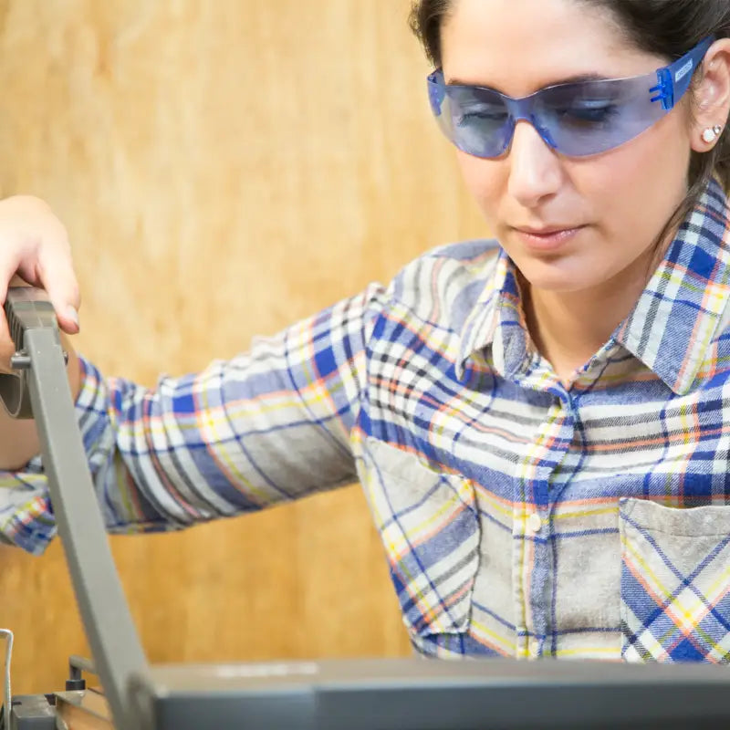 Woman wearing clear safety glasses for comfortable high impact protection