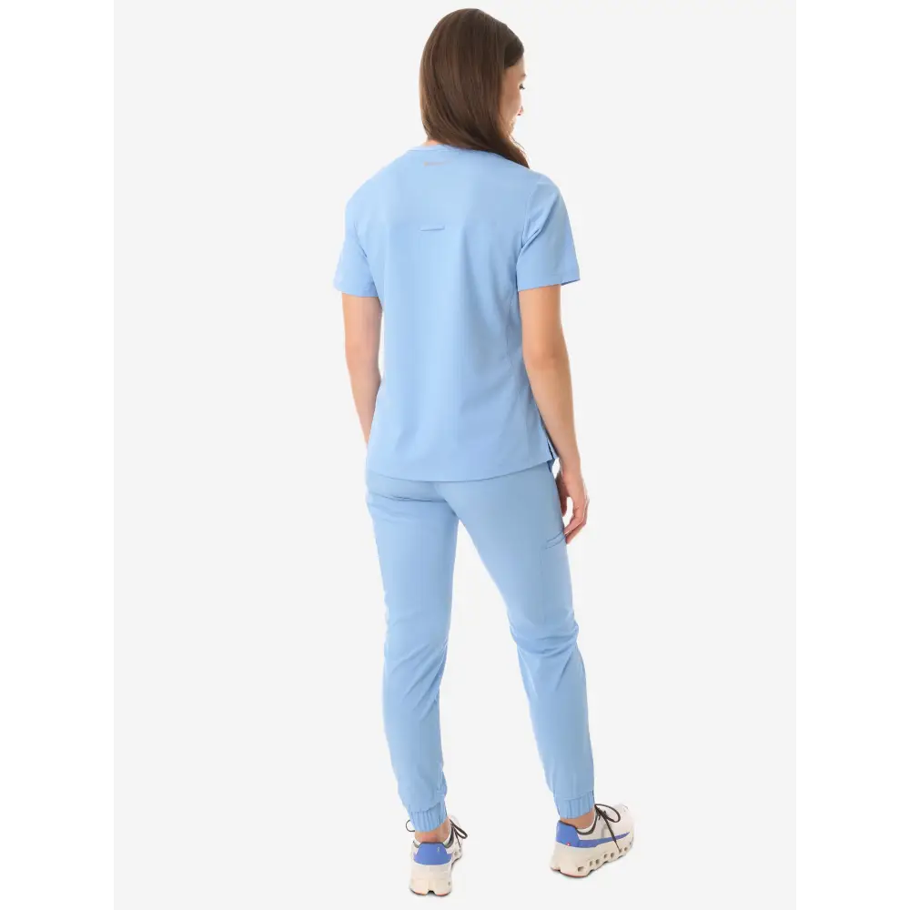 Light blue women’s four-pocket scrub top with matching pants for medical professionals