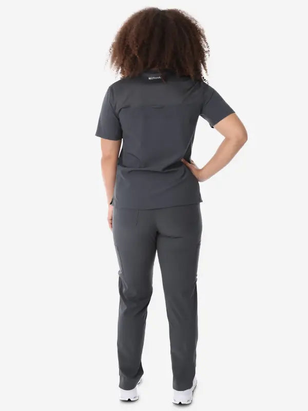 Dark gray women’s four-pocket scrub top with short sleeves and fitted pants