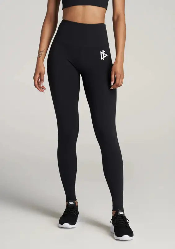 Black athletic leggings with white logo, perfect for women’s top-tier leggings style