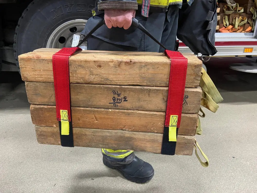 Wooden cribbing blocks with red straps and reflective yellow tabs for cribbing strap short