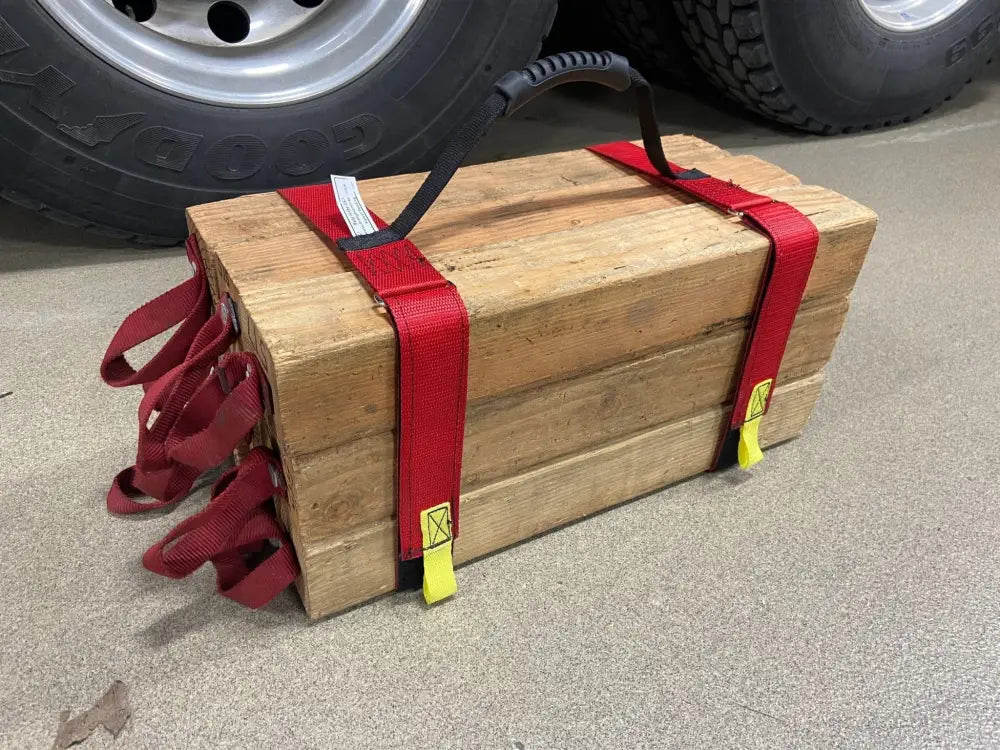 Wooden crate with red straps holding tools showcasing Cribbing Strap Short-FFCS8