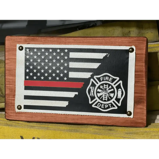 Wooden plaque featuring a red line Maltese cross and Fire Department emblem hose flag sign