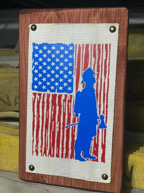 Wooden hose sign featuring American flag and firefighter silhouette for first responders