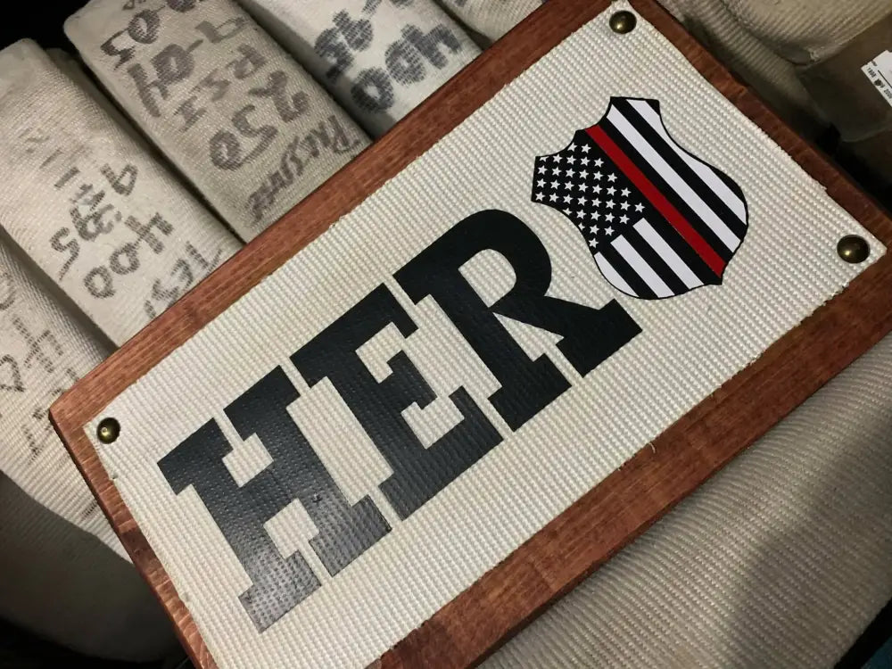 Wooden sign with HERO and red line flag badge for Fire Hose Sign display