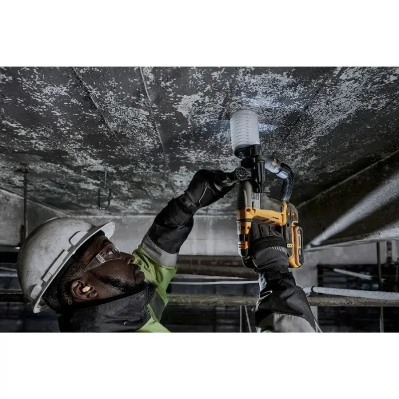 Worker in safety gear using DEWALT DCH172D2 Atomic 20V MAX Brushless Cordless SDS tool