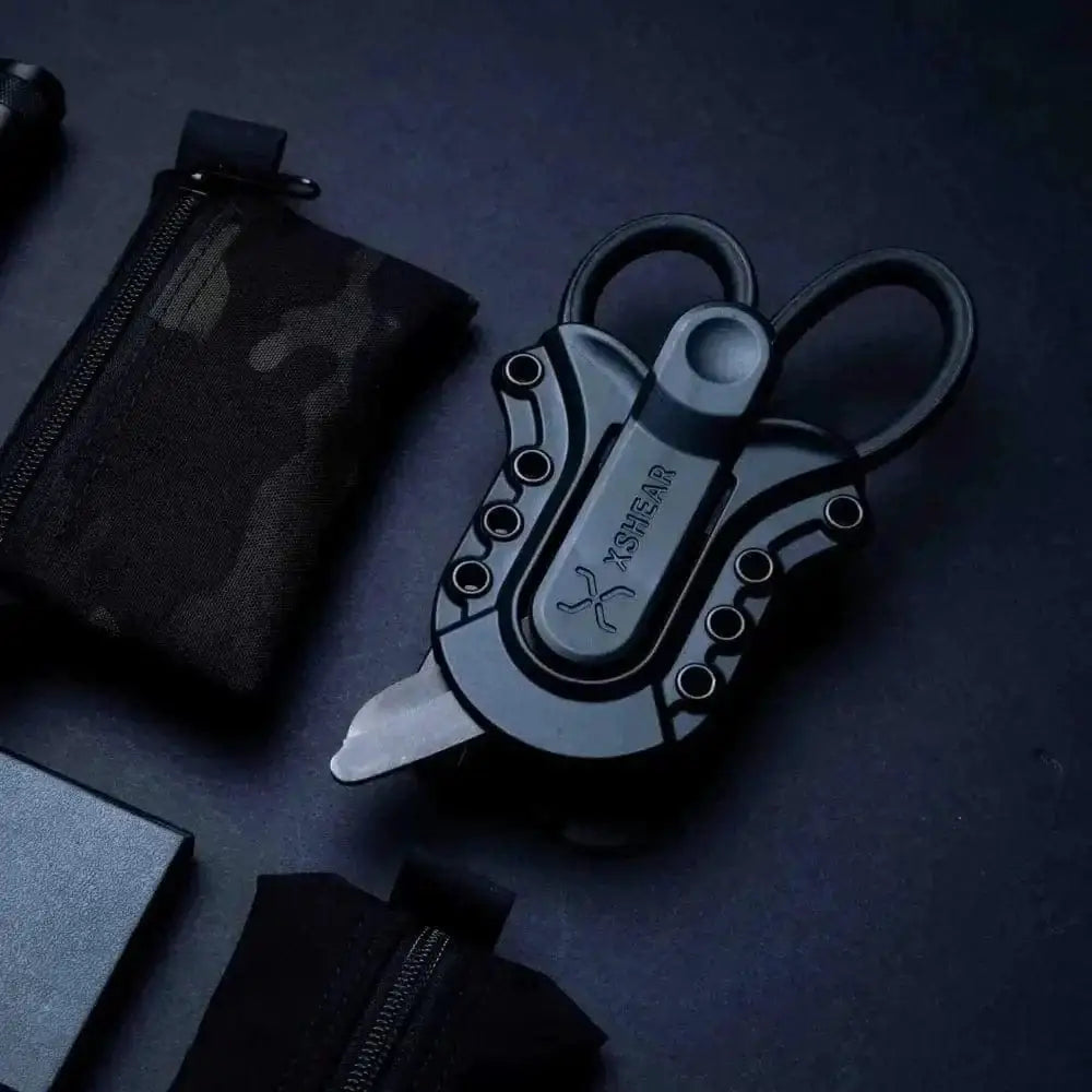 Metallic folding scissors in XShear Tactical Holster, showcasing sleek modern design