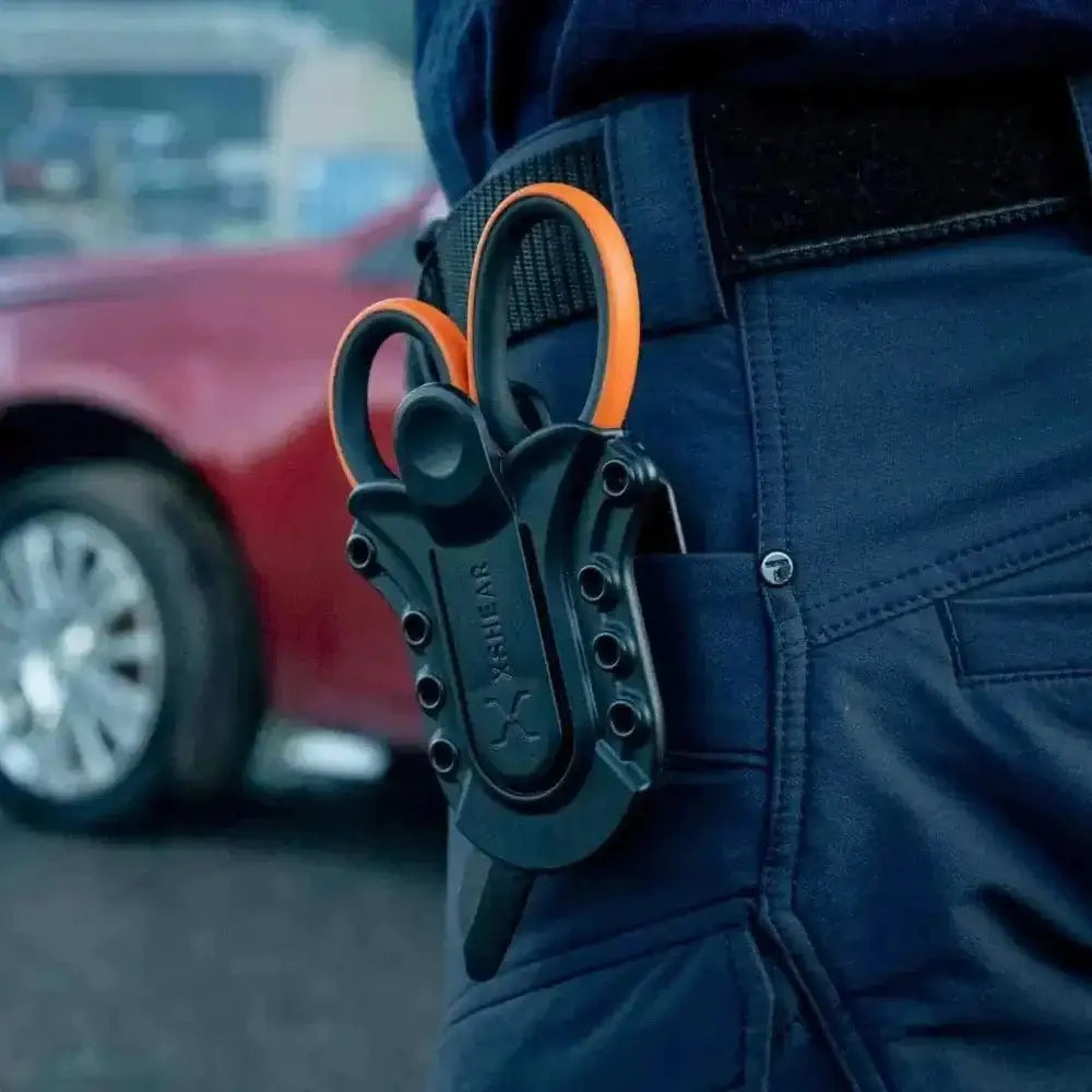 Black tactical scissors with orange handles in XShear Tactical Holster