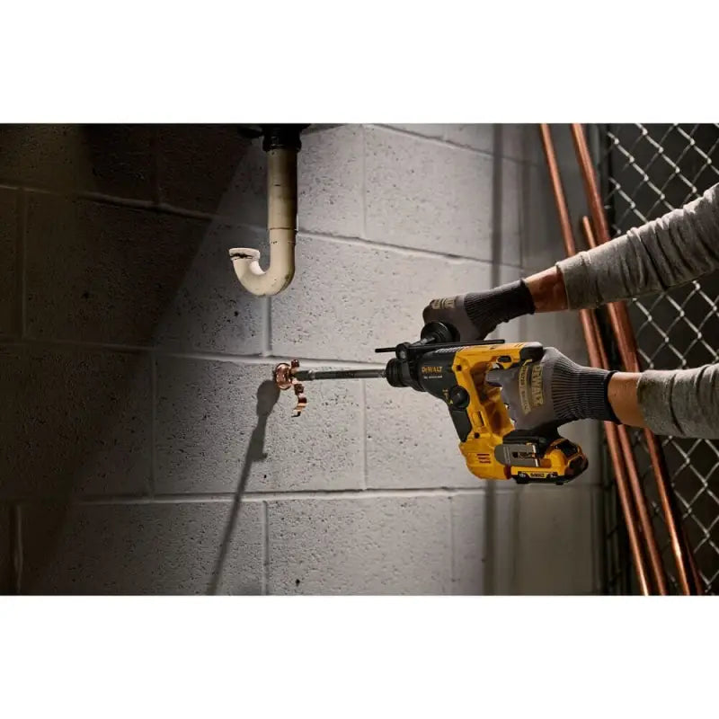 Yellow and black DeWalt DCH072B Xtreme 12V MAX Brushless Cordless Rotary Hammer drilling concrete