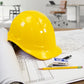 Yellow cap style safety hard hat with 4 point suspension on blueprints