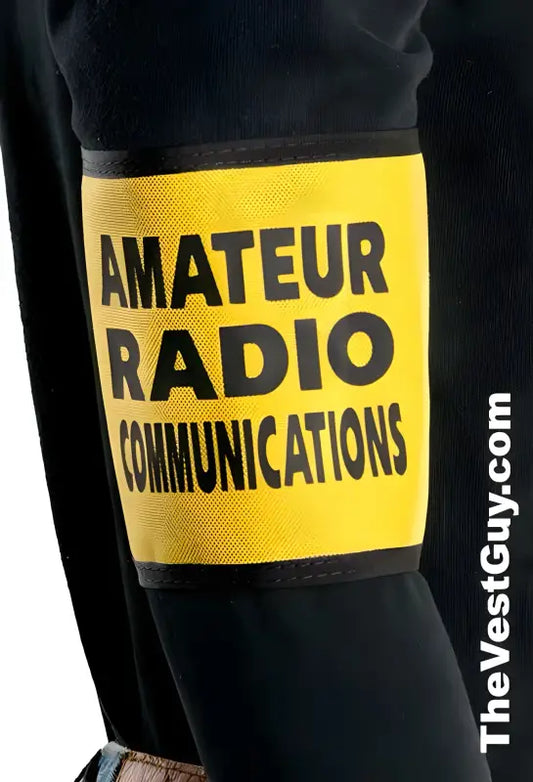 Yellow label on dark surface reads Amateur Radio Communications for radio communications armband