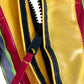 Yellow and red vinyl firefighting nozzle cover with black zipper for weather nozzle protection