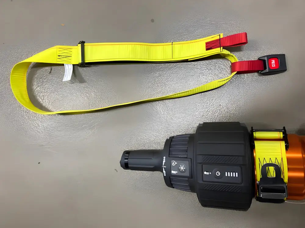 Yellow extrication tool carrying strap with black and red buckles for secure use