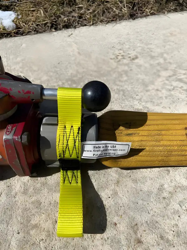 Yellow strap securing black knob in Gated Wye Strap - FFGWS for interior firefighters