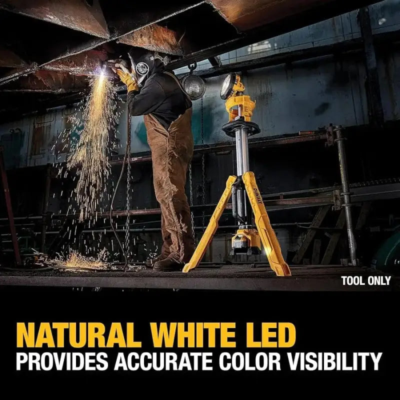 Yellow tripod-mounted LED work light illuminates workspace with DEWALT DCL079B 20V cordless tripod light